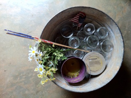 antique wash tub with mason jars, flowers, candles and flag